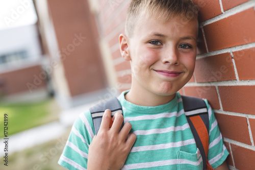 Pre teen boy outside at school photo