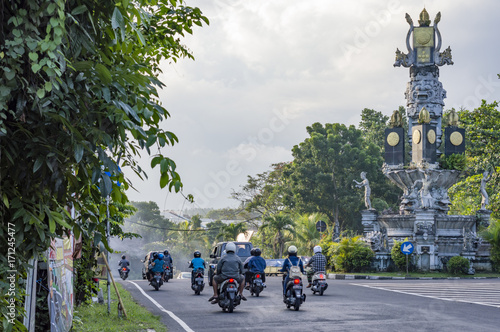 People drive motorbikes on the street in Bali, Indonesia