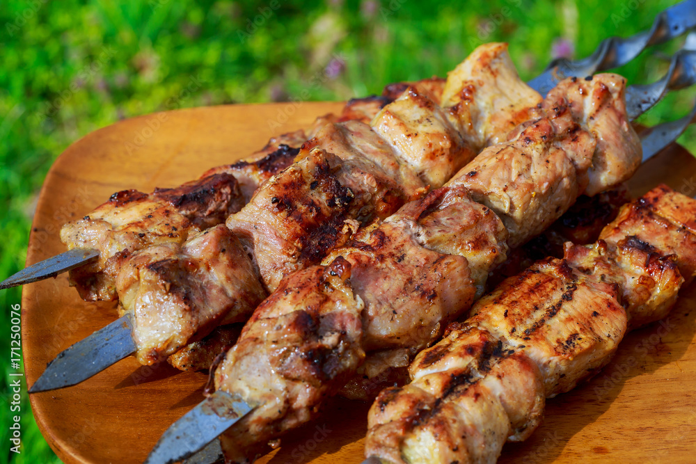 closeup of some meat skewers being grilled barbecue