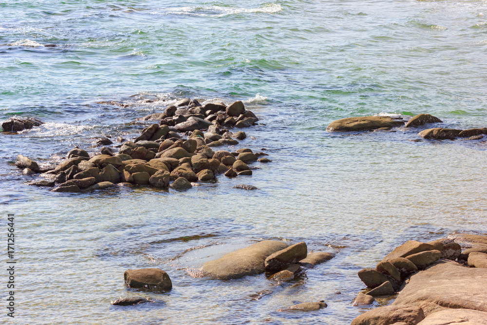 Obraz premium Stone beach of the Sea at summer day