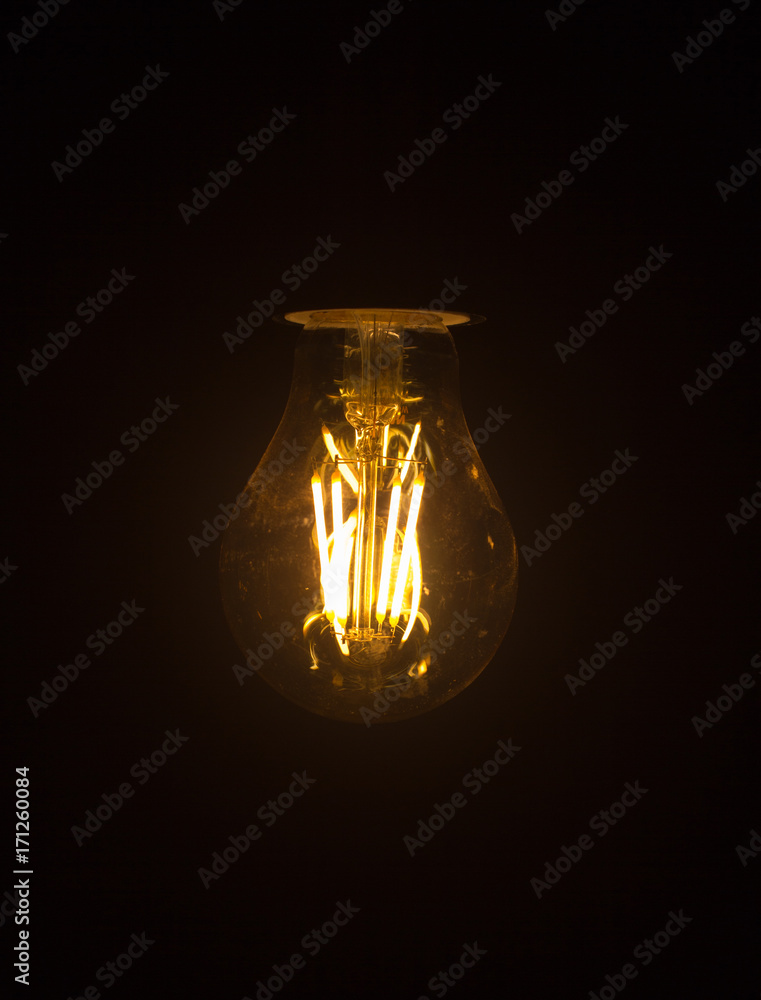 Light bulb hanging on black background. Light bulb hanging on black background.
