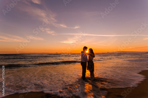 Silhouetted couple at Huntington Beach