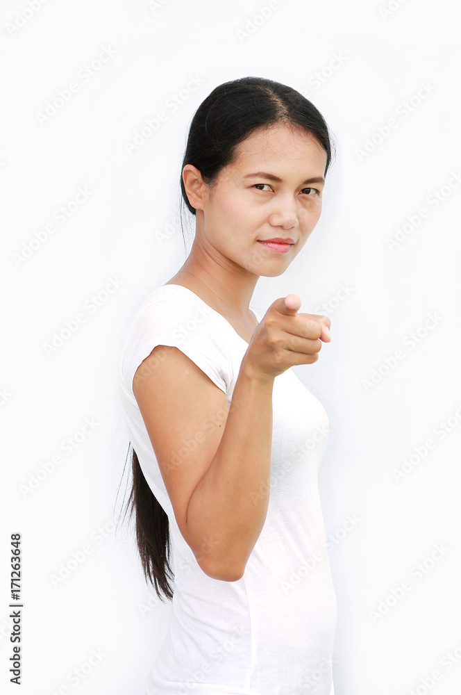 Young asian woman in T-Shirt pointing finger at you on white background, Selected focus at her face Young asian woman in T-Shirt pointing finger at you on white background, Selected focus at her face