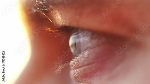 Extreme macro close up of male eye watching sunset by the sea. Enjoying nature in slow motion, HD. 1920x1080