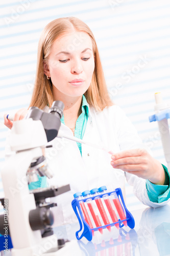 A nurse in a hospital laboratory tests a blood