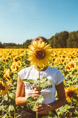 Beautiful stylish hippie girl on the sunflower field