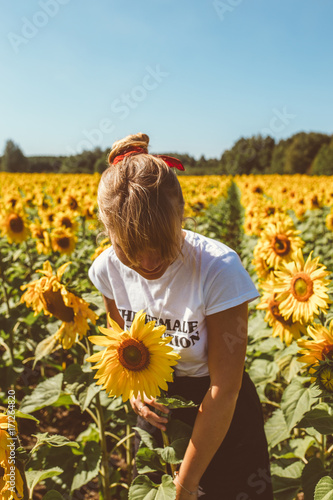 Beautiful stylish hippie girl on the sunflower field