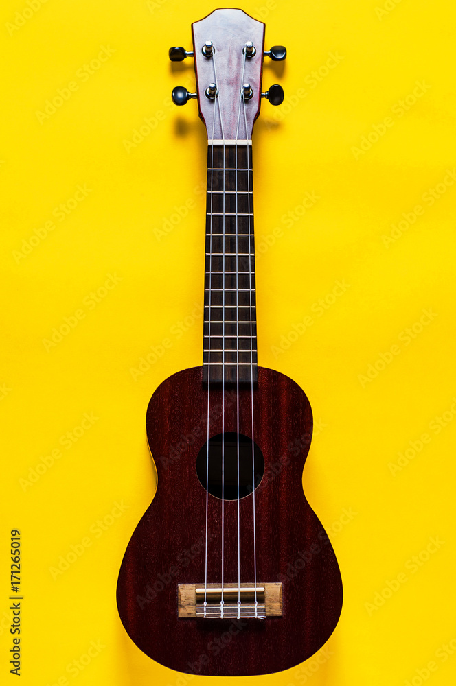 Obraz premium Ukulele on yellow background. Music or arts concept