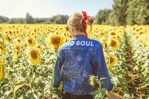 Beautiful stylish hippie girl on the sunflower field