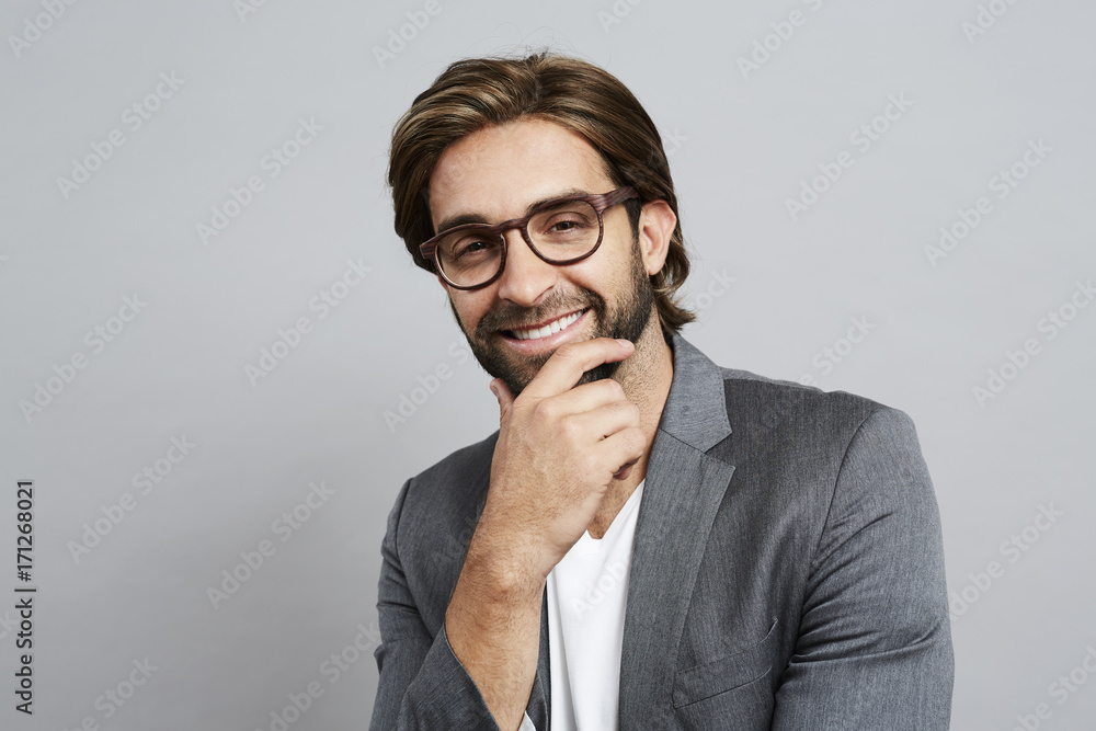 Thoughtful guy in grey suit jacket and glasses Thoughtful guy in grey suit jacket and glasses