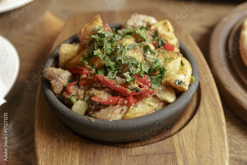 Restaurant Shot. Meat in a hot pan, baked with potatoes and vegetables. Caucasian kitchen.