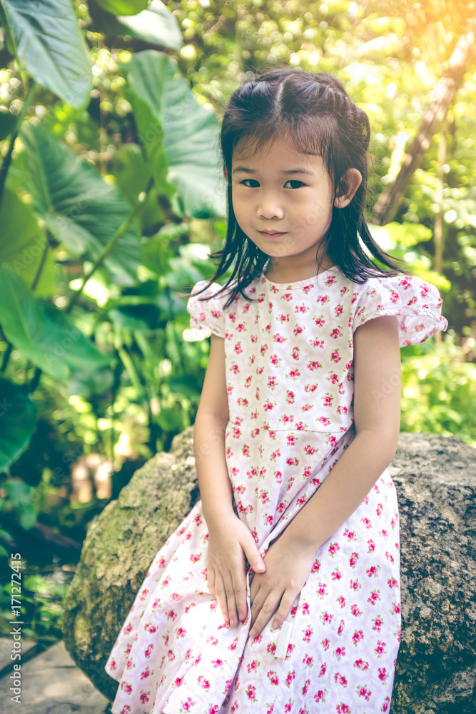 Adorable asian child smiling and relaxing at park with sunlight, travel on vacation. Adorable asian child smiling and relaxing at park with sunlight, travel on vacation.