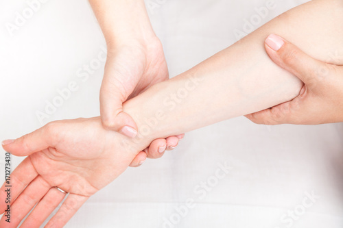Woman receiving osteopathic treatment of her wrist