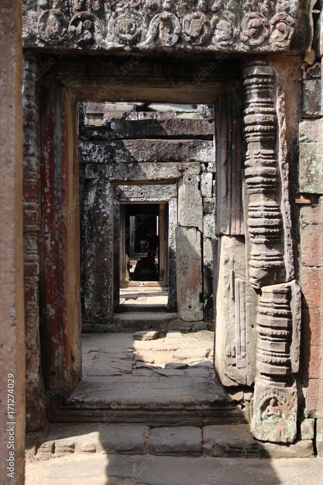 Ruins and walls of an ancient city in Angkor complex, near the ancient capital of Cambodia - Siem Reap Ruins and walls of an ancient city in Angkor complex, near the ancient capital of Cambodia - Siem Reap