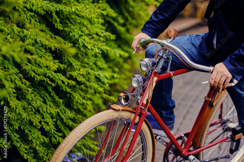 Close up image of a man on a retro bicycle. Close up image of a man on a retro bicycle.
