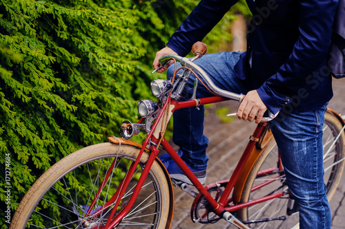 Close up image of a man on a retro bicycle.