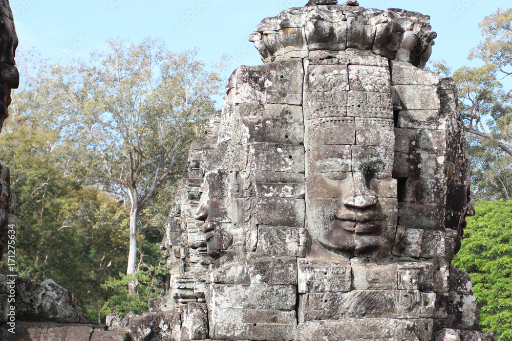 The ruins of an old temple with stone heads and faces in Cambodia