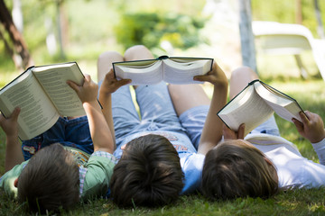 Three children reading in the garden