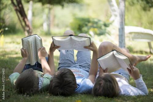 Three children reading in the garden