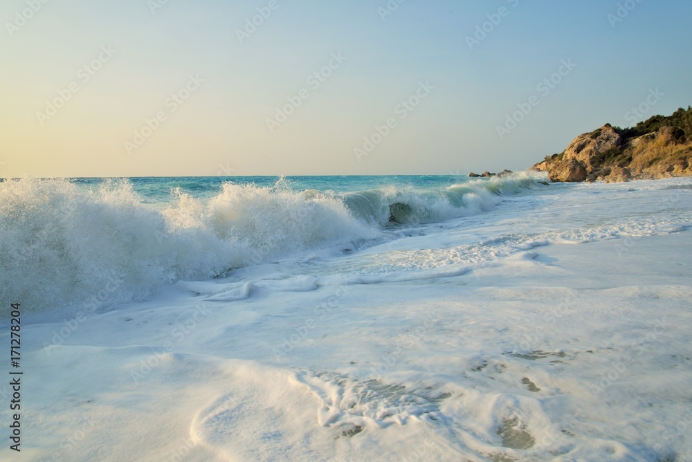 Enormous waves crashing on the shore and on the rocks at the Megali Patra Beach at the sunset, Lefkada Island, Greece