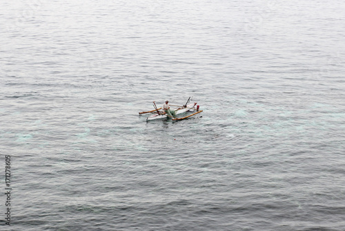 Fishermen on canoe. Philippines