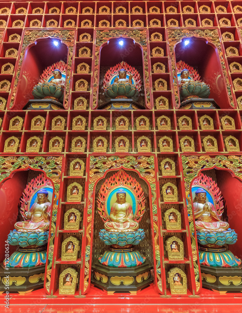Wall with small colorful Buddha statues inside  the Buddha Tooth Relic Temple and Museum in Singapore Chinatown