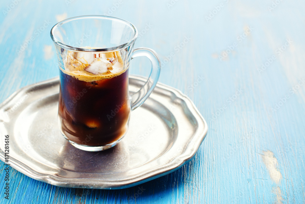 Refreshing iced coffee with cream over blue summer background Refreshing iced coffee with cream over blue summer background
