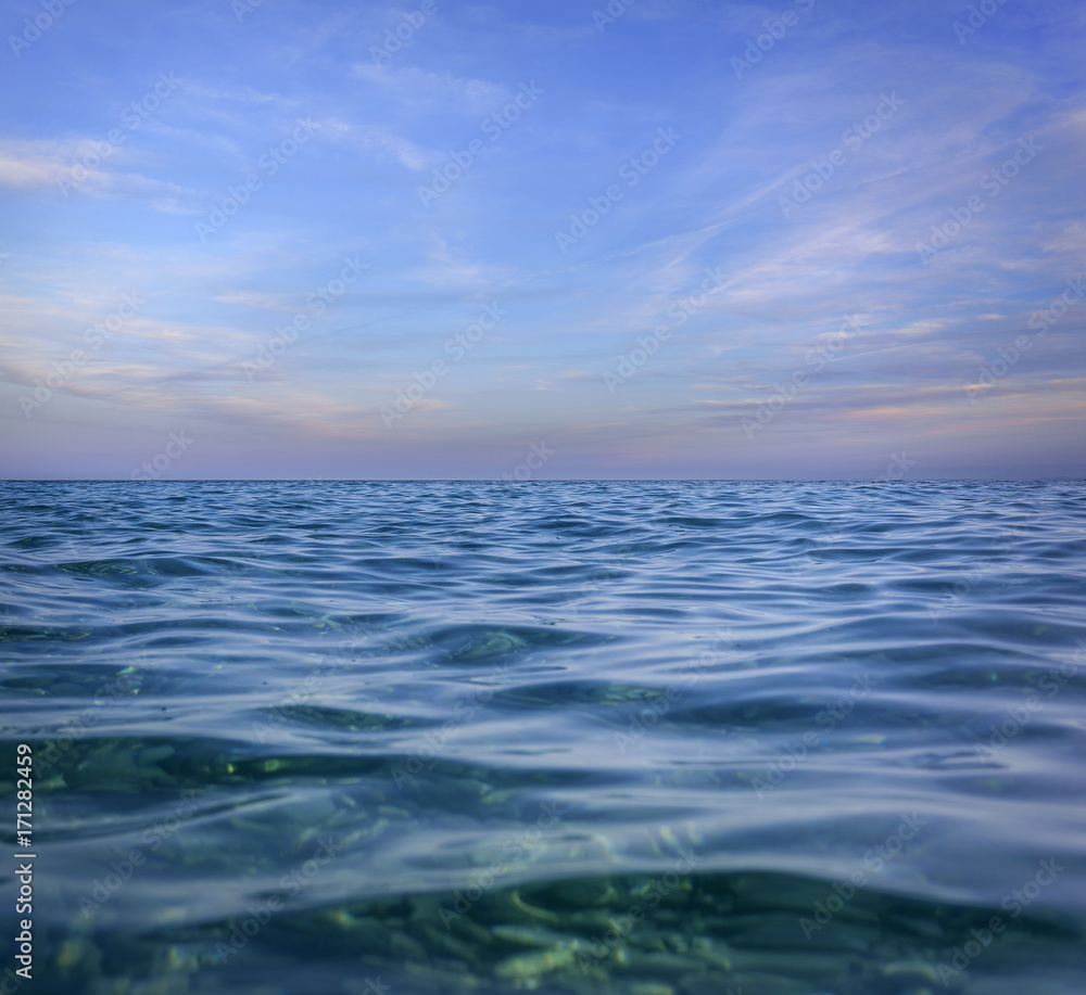 Blue sky with clouds over the sea.