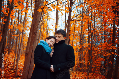 Young couple in autumn Park. Cute guy and a girl walking together © Ulia Koltyrina