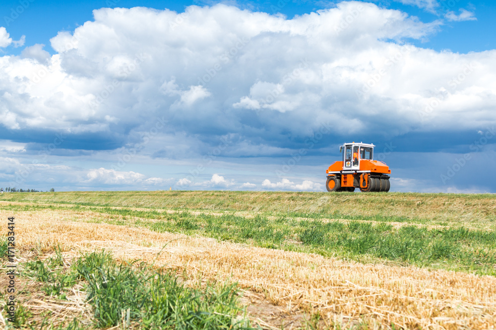 Orange tractor in the field