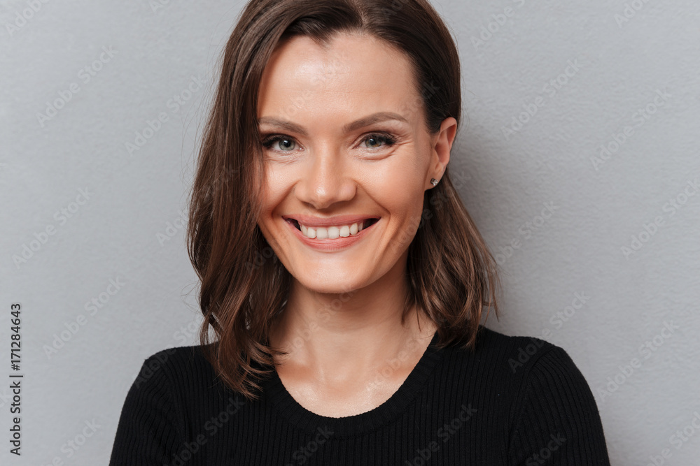 Close up picture of smiling woman in black dress Close up picture of smiling woman in black dress