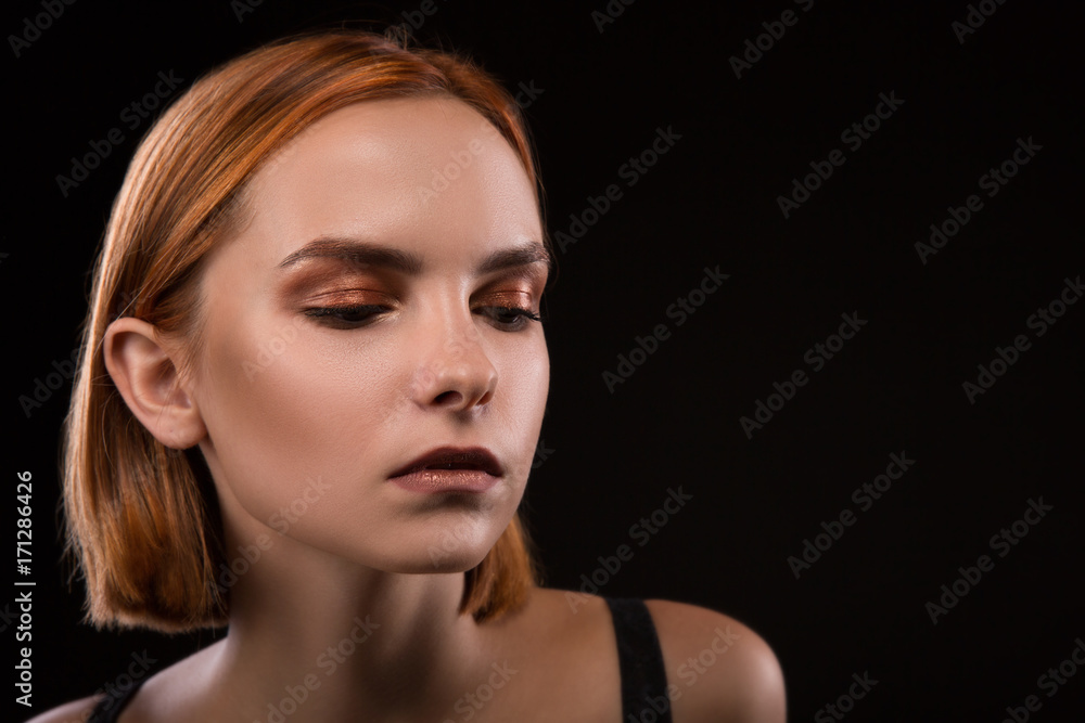 Sad blond woman portrait against black background Sad blond woman portrait against black background