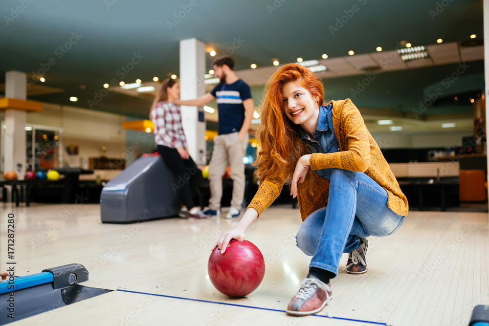 Fototapeta premium Friends having fun while bowling