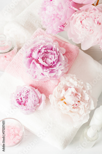 bath and spa with peony flowers beauty products towels © Olga Miltsova