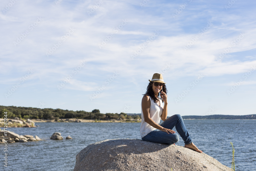 happy young beautiful woman talking on her mobile phone at sunset. Blue sky background. Outdoors. Lifestyle happy young beautiful woman talking on her mobile phone at sunset. Blue sky background. Outdoors. Lifestyle