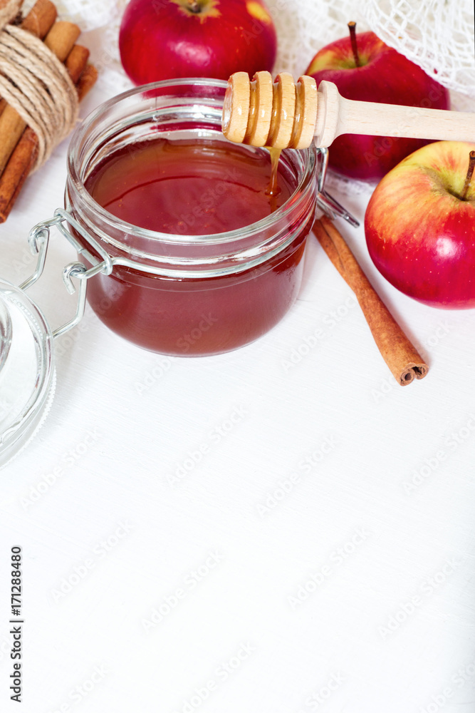 honey, apple and cinnamon on white wooden background, with space for text honey, apple and cinnamon on white wooden background, with space for text