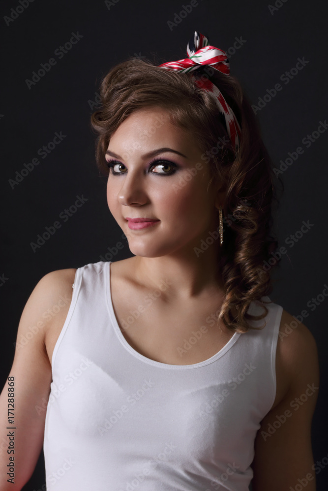 Pinup beautiful girl in white and with curly hair poses in black studio Pinup beautiful girl in white and with curly hair poses in black studio