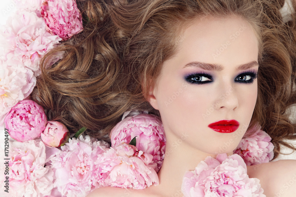 Vintage style portrait of young beautiful girl with stylish make-up and pink flowers in her hair