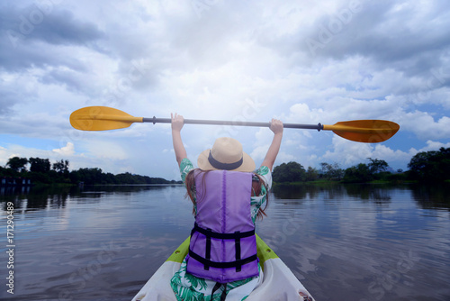 Woman is enjoy kayaking in the river