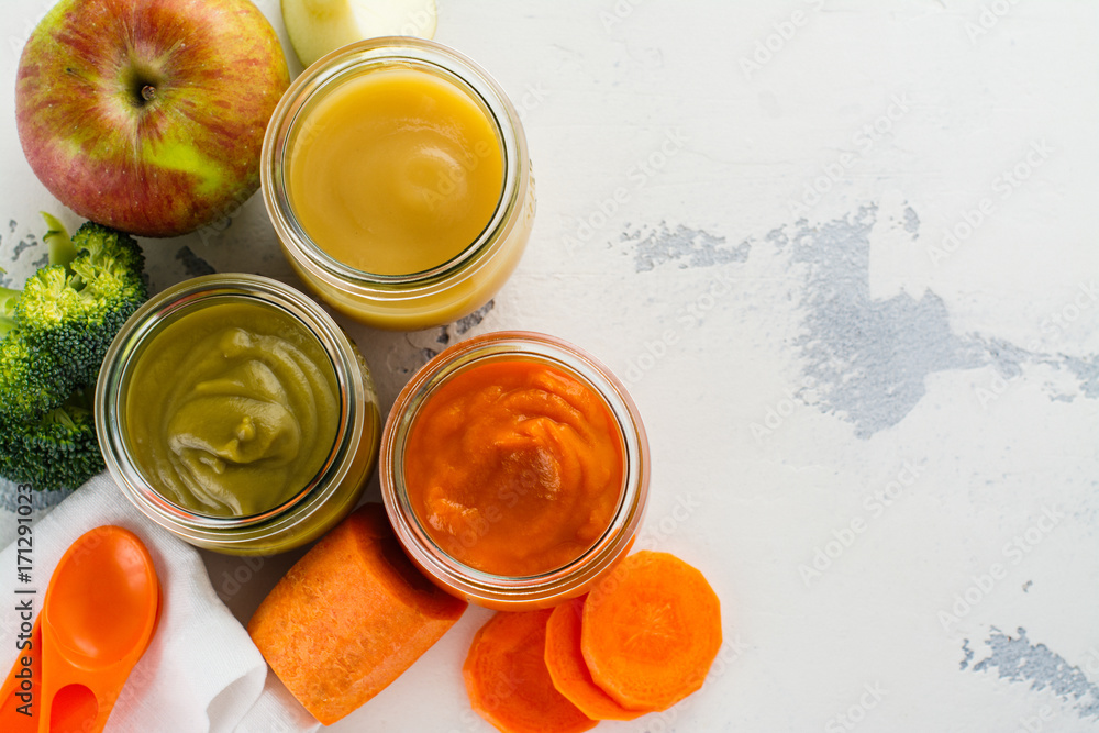 Homemade vegetable and fruit puree with ingredients on white background. Space for text Homemade vegetable and fruit puree with ingredients on white background. Space for text