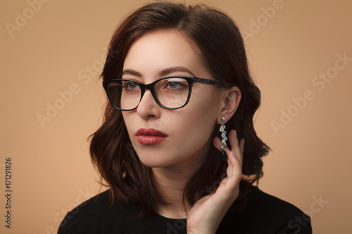 Confident pretty model wearing glasses