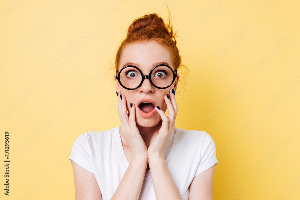 Close up picture of shocked ginger woman in eyeglasses Close up picture of shocked ginger woman in eyeglasses