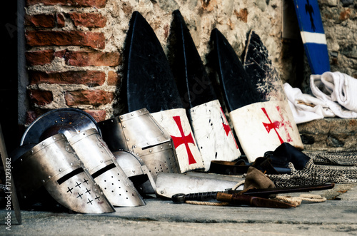 Εκτύπωση καμβά Medieval weapons, shields and helmets from the crusade age on a castle floor dur