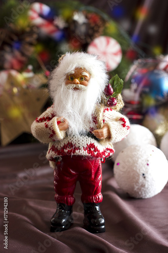 Santa Claus and Christmas tree toys in a round glass vase
