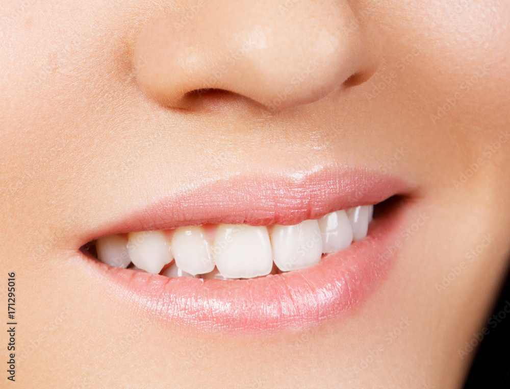 Naklejka premium Woman's smile. Healthy white woman's teeth. Dental hygiene, oral care concept. Teeth whitening. Stomatology concept