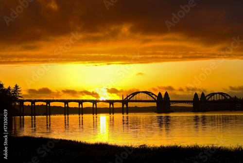 Brilliant orange sunset over Florence Historic Bridge  Oregon coast