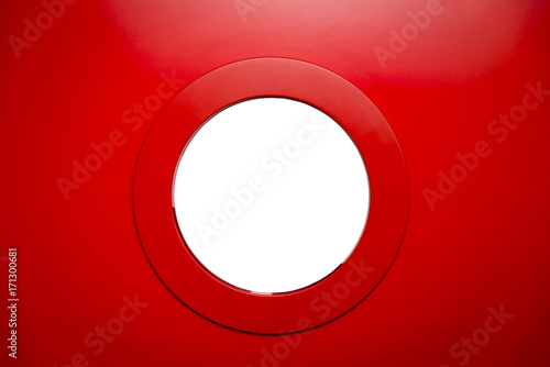round white porthole in the red door.Copy space