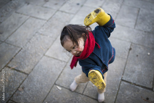 Happy Little Girl and Yellow Rain Boots