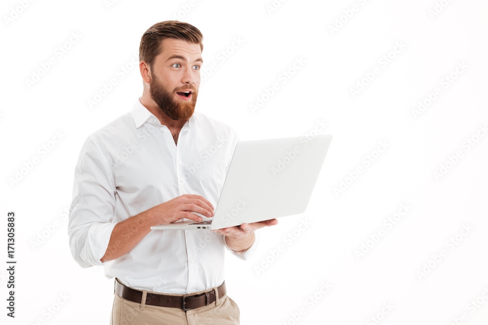 Handsome young bearded man using laptop. Handsome young bearded man using laptop.