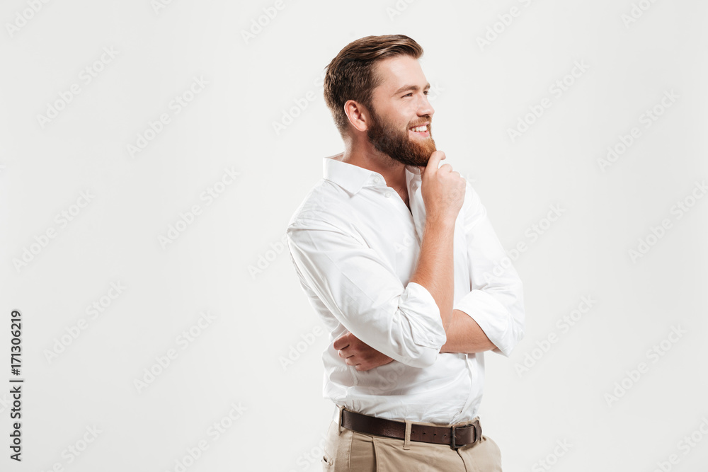 Happy young bearded man looking aside. Happy young bearded man looking aside.